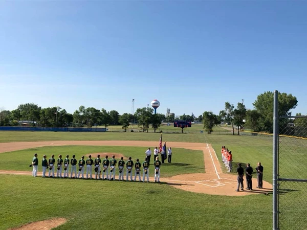 Baseball players lined up for the national athem.